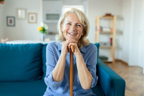 woman with cane smiling